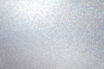 Iridescent brilliance sparkles blurred pattern on grey background.