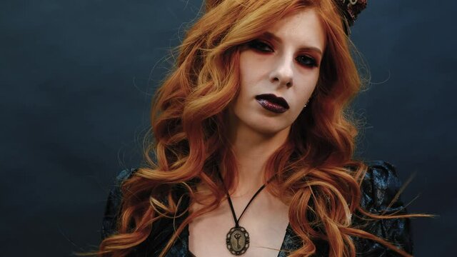 Steampunk gothic girl poses for the camera in slow-mo shooting
