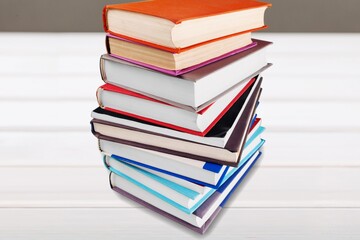 Stack of old study books on the wooden desk