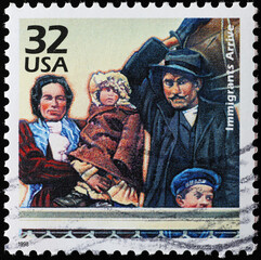 Obraz na płótnie Canvas Immigrants arriving to Ellis island in on american stamp