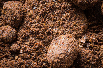 background in the form of a young black instant coffee texture and piece of rock. closeup top view