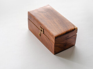 Old wooden box with metallic buckle on a white background