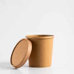 Empty paper soup cup on a white background. Brown food container for ice cream, noodles or other dishes. ecological product that can decompose naturally.