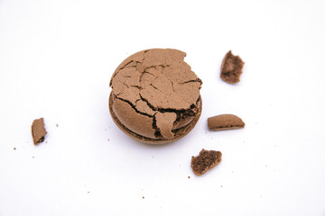 Cookies with chocolate filling on a white background.Broken cookies, crumbs around them.