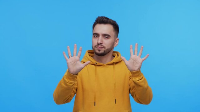 Expressive young man over vibrant background. Studio portrait of borred person.