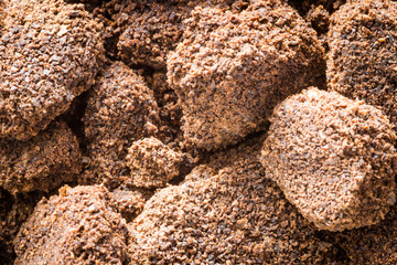 background in the form of a young black instant coffee texture and piece of rock. closeup top view