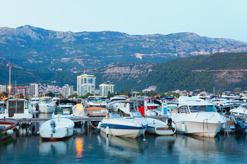 Fototapeta na wymiar boats in harbour , scenery with nautical harbour in the evening , landscape of Budva city in Montenegro 