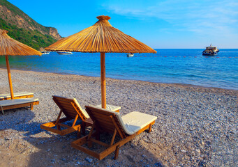 beach relax at sun loungers with exotic umbrellas 