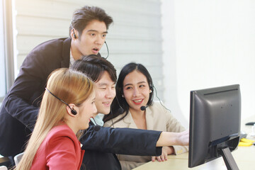 Business Call Center and technical Support staff or receptionist phone operator Discussing and working for teamwork with computer. Asian customer support team.