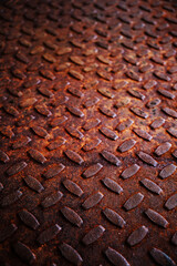 Old and rusty metal floor. Texture of a rough metal sheet with a convex pattern.