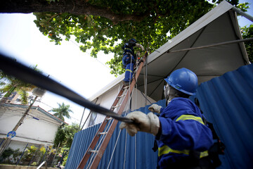 salvador, bahia / brazil -  february 28, 2019: Electrician makes repairs to the power grid during...