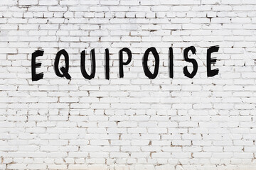 White wall with black paint inscription equipoise on it