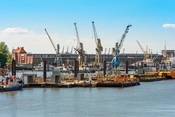 Fototapeta premium The Hansa harbor, located in the Hamburg district Kleiner Grasbrook in the south of the city and the German Port Museum at the quay and the sheds 50