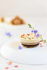 Cashew cake decorated with flowers and sublimated berries. No sugar, gluten, lactose.