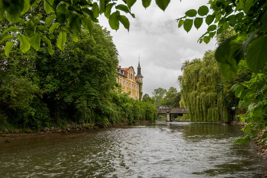 Famous old stone bridge with engraved city arms over the river Amper in the bavarian town Fuerstenfeldbruck on cloudy overcast day