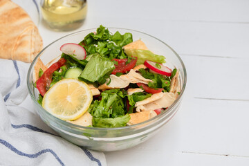 Fattoush pita bread salad in a glass bowl