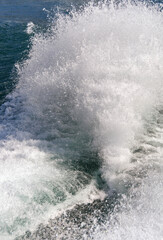 Fototapeta premium Water spray thrown up by the wake of a fast ferry