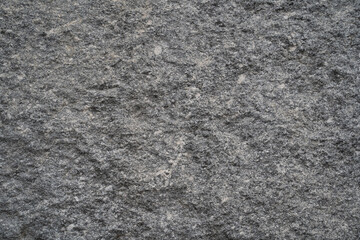 Stone surface texture of the gray granite wall