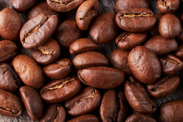 Fototapeta premium coffee beans close up on a wooden background