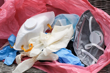 Medical dirty waste mask and gloves in garbage bin,coronavirus disease equipment items