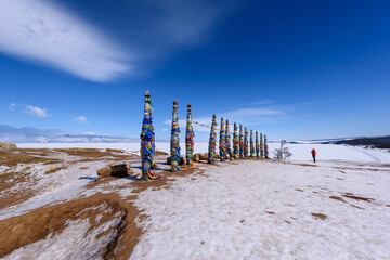 Silhouette of person takes photo of sacred buryat place on Olkhon island, lake Baikal, Russia