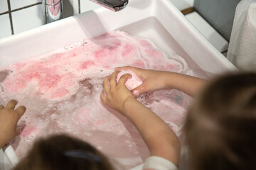 Fototapeta premium Hygiene and care, children wash their hands in the sink.