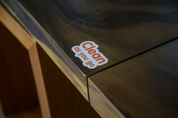 Clean as you go sticker on the restaurant table