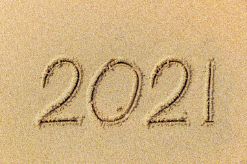 Inscription 2021 on the sand