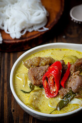 Green Curry beef with rice and Rice Noodles on wood table, Thai food