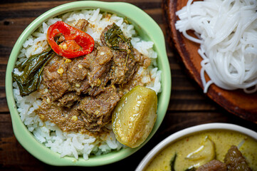 Green Curry beef with rice and Rice Noodles on wood table, Thai food