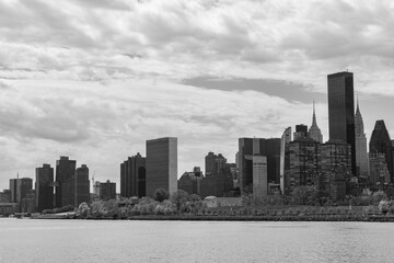 Black and White Manhattan Skyline along the East River in New York City with a Cloudy Sky