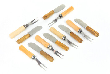 Wooden pickle forks and jam knives isolated on white background