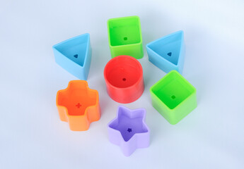 Obraz premium Isolated children's toy blocks in various shapes made of plastic on white background 