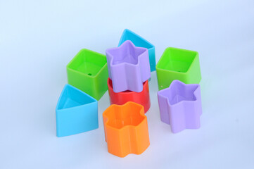 Obraz premium Isolated children's toy blocks in various shapes made of plastic on white background 