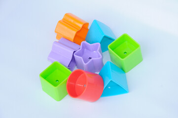 Naklejka premium Isolated children's toy blocks in various shapes made of plastic on white background 