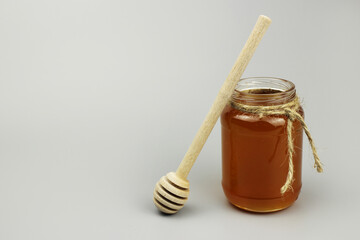 honey dipper and glass jar