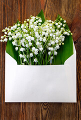 Bouquet of lilies of the valley in an envelope