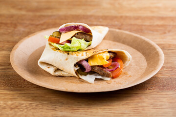 roll with beef patty with fresh vegetables and cheese