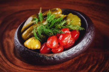 Mixed pickles platter served on the wooden table 