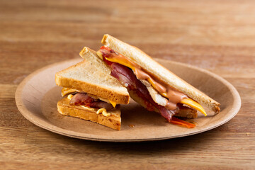 toast bread sandwich with bacon, cheese and cream sauce