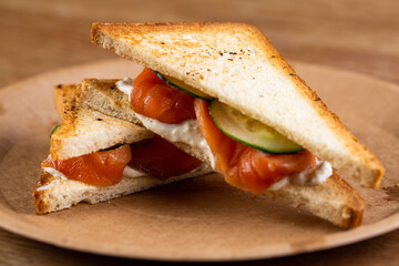 red fish sandwich with fresh cucumbers and cream sauce