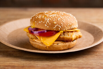 cheeseburger with chicken nuggets, fresh tomato and onions