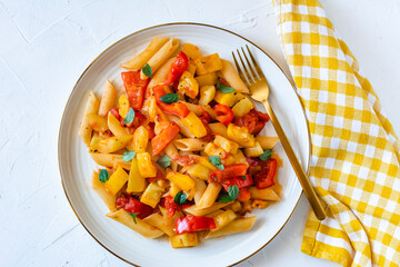 Penne pasta in a tomato sauce with zucchini and red pepper