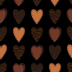 Vector seamless pattern with doodle hearts of different colors of chocolate on black background. Cute backdrop for print, textile, Valentines day, sweet shop, cover, wallpaper.