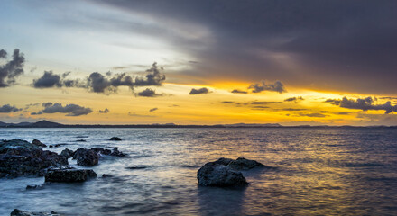 Fototapeta na wymiar Breaking dawn before sunrise at Koh Samet Island in Thailand. Rocks on the Ao Noi Na Beach of Koh Samed island.