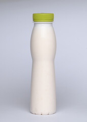 White with green cup blank plastic bottle of milk on the white background