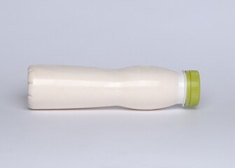 White with green cup blank plastic bottle of milk on the white background