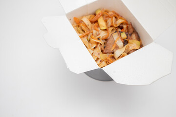 Noodles in black carton takeaway box. Chinese food. Selective focus