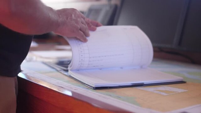 sailor reading nautical chart map ship boat slow motion