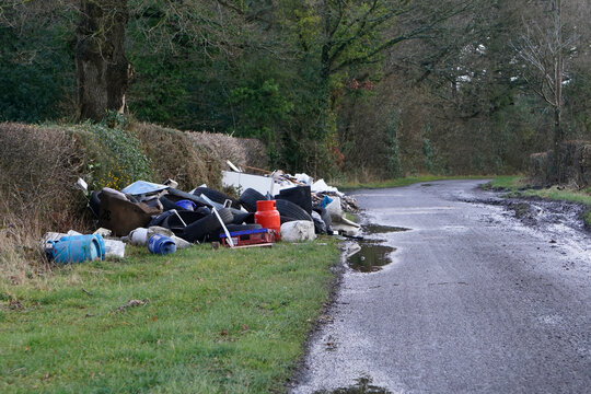 Fly-tipping or illegal waste dumping in a country lane in the UK